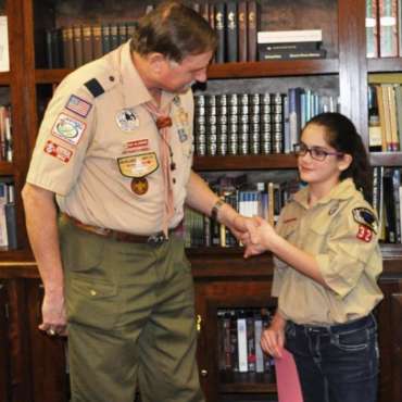 Congratulating the first official girl Cub Scout east of the Mississippi
