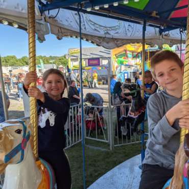 Emily and James on the Merry-go-Round at the Mineral County Fair